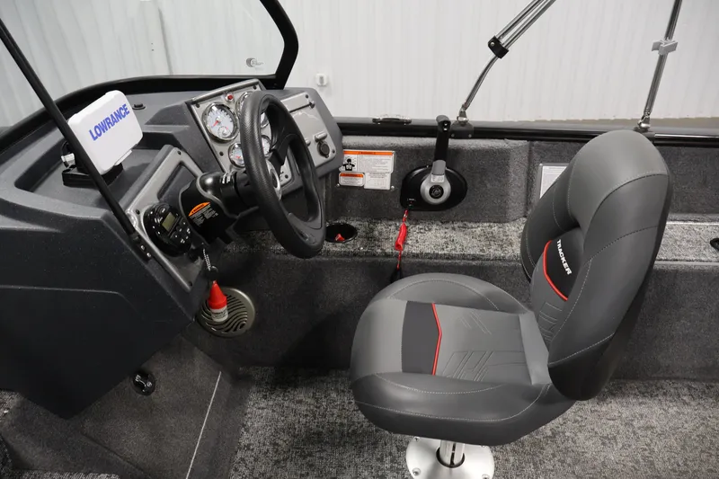 Slide: The Image of 2025 Tracker Pro Guide V-175 WT boat interior with steering wheel and control panel. - 20
