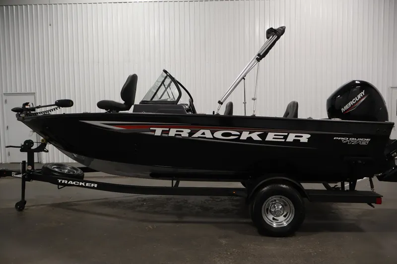 Slide: The Image of 2025 Tracker Pro Guide V-175 WT boat on trailer in indoor setting. - 8