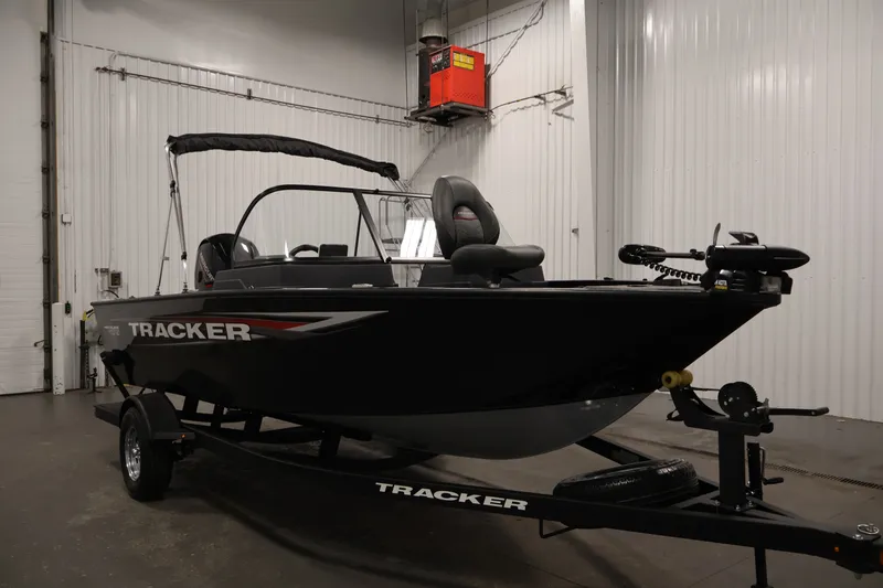 Slide: The Image of 2025 Tracker Pro Guide V-175 WT boat in a showroom, featuring sleek design and modern equipment. - 3