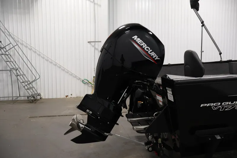 Slide: The Image of 2025 Tracker Pro Guide V-175 WT boat with Mercury outboard motor in a garage setting. - 46
