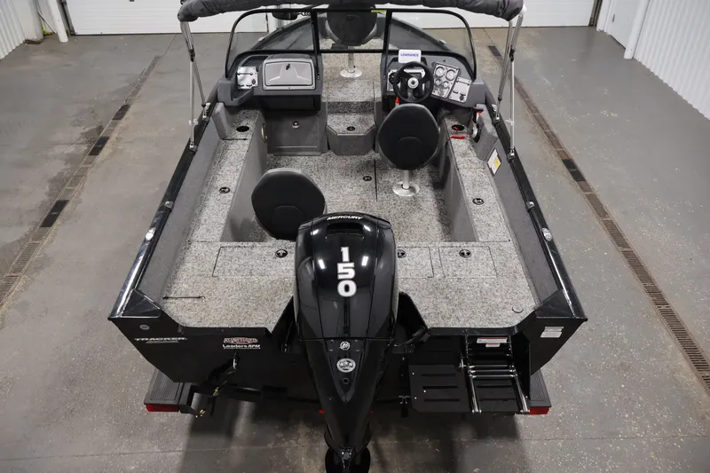 Slide: The Image of 2025 Tracker Pro Guide V-175 WT boat interior with 150 HP engine, gray flooring. - 10