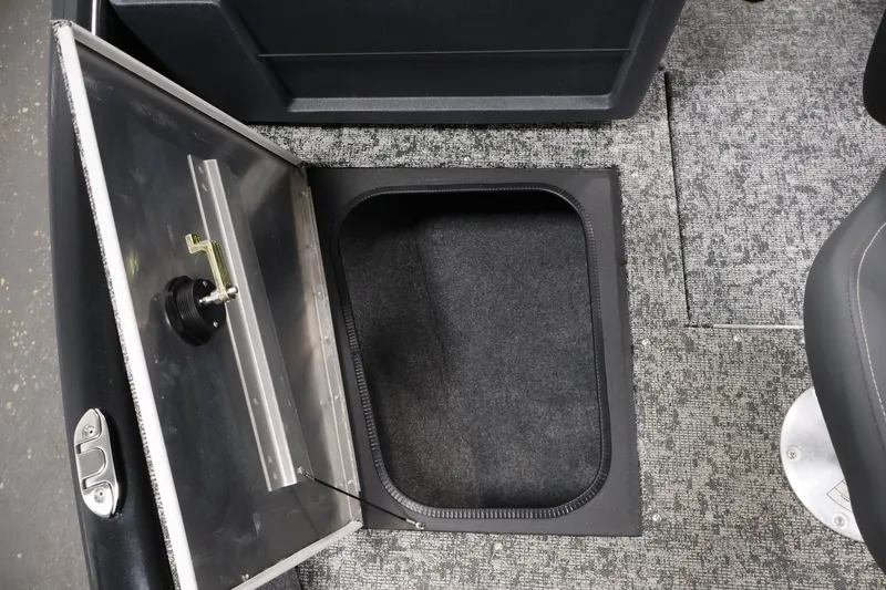 Slide: The Image of 2025 Tracker Pro Guide V-175 WT boat storage compartment with open hatch on carpeted floor. - 17