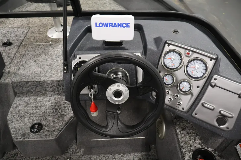 Slide: The Image of 2025 Tracker Pro Guide V-175 WT boat dashboard with steering wheel and gauges. - 21