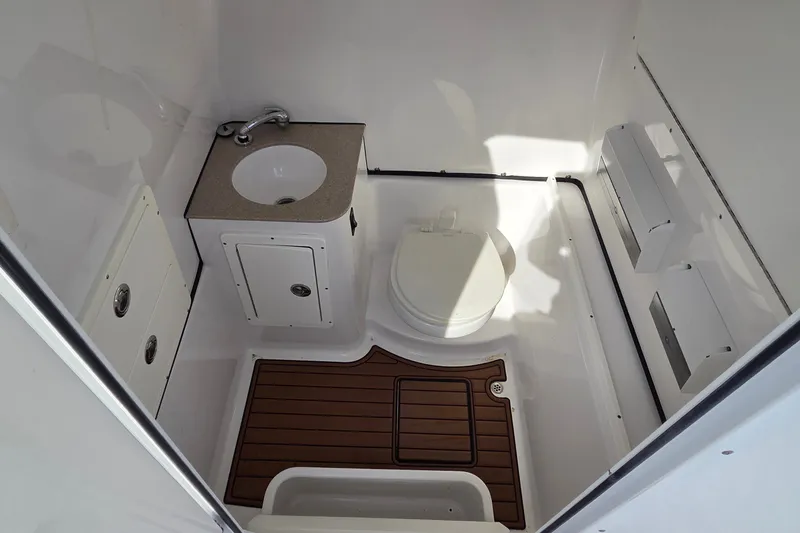 Slide: The Image of 2018 Sportsman Open 312 Center Console boat bathroom with sink and toilet. - 23