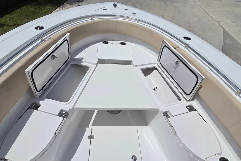 Slide: The Image of 2018 Sportsman Open 312 Center Console boat interior with storage compartments open. - 7
