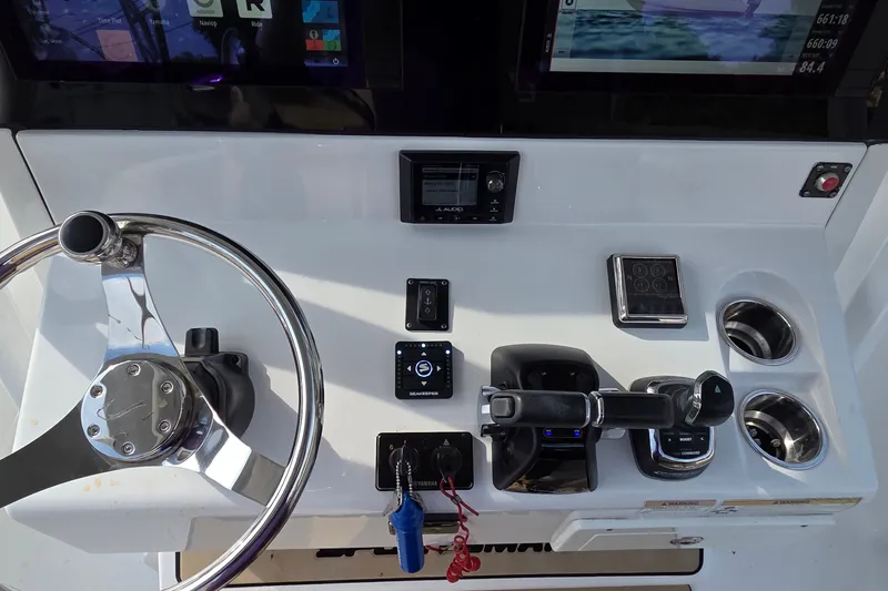 Slide: The Image of 2018 Sportsman Open 312 Center Console dashboard with steering wheel and controls. - 20