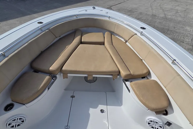 Slide: The Image of 2018 Sportsman Open 312 Center Console boat with tan cushioned seating area. - 22