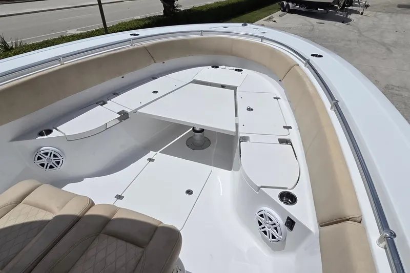 Slide: The Image of 2018 Sportsman Open 312 Center Console boat interior with seating and table. - 6
