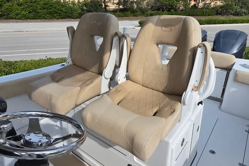 Slide: The Image of 2018 Sportsman Open 312 Center Console with beige cushioned seats and steering wheel. - 10