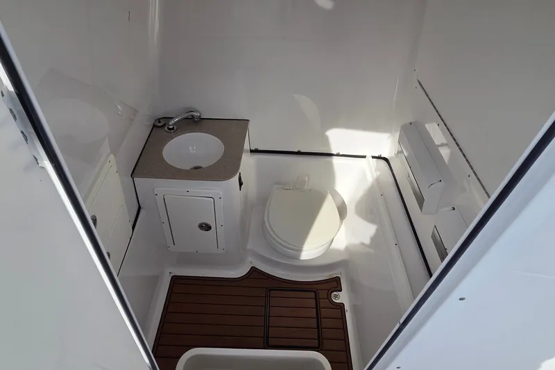 Slide: The Image of 2018 Sportsman Open 312 Center Console boat bathroom with sink and toilet. - 24