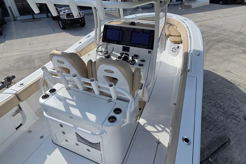 Slide: The Image of 2018 Sportsman Open 312 Center Console boat with dual helm seats and navigation screens. - 26