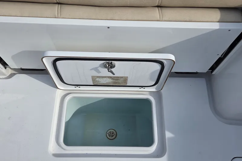 Slide: The Image of 2018 Sportsman Open 312 Center Console livewell with open lid and seating above. - 15