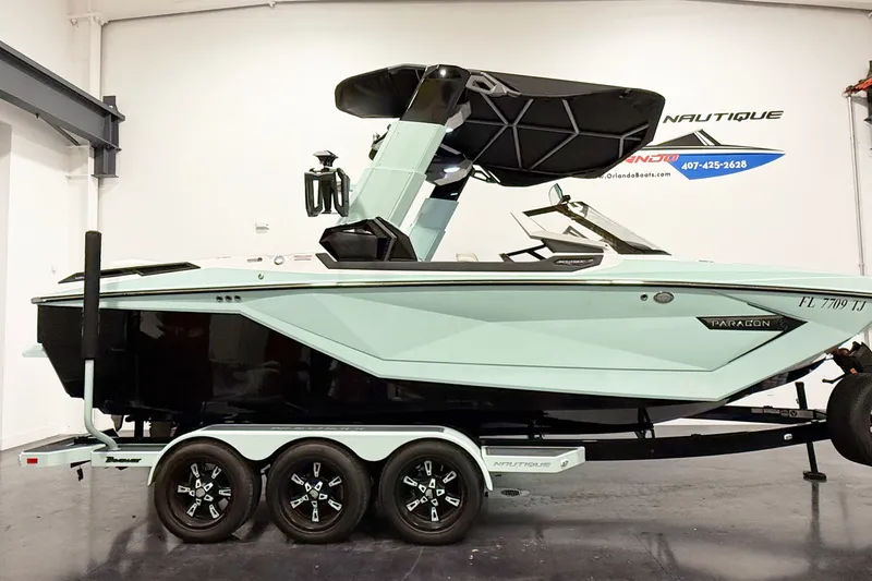 The Image of 2023 Nautique Super Air Nautique G23 Paragon boat on trailer in showroom. - 1
