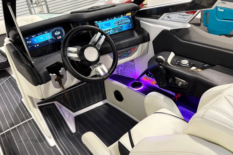 Slide: The Image of 2023 Nautique Super Air Nautique G23 Paragon cockpit with modern controls and illuminated dashboard. - 6