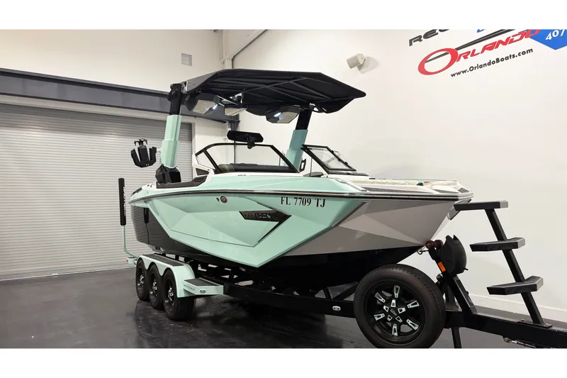 Slide: The Image of 2023 Nautique Super Air Nautique G23 Paragon boat on trailer in showroom. - 2
