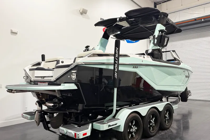 Slide: The Image of 2023 Nautique Super Air Nautique G23 Paragon boat in showroom, rear view. - 4