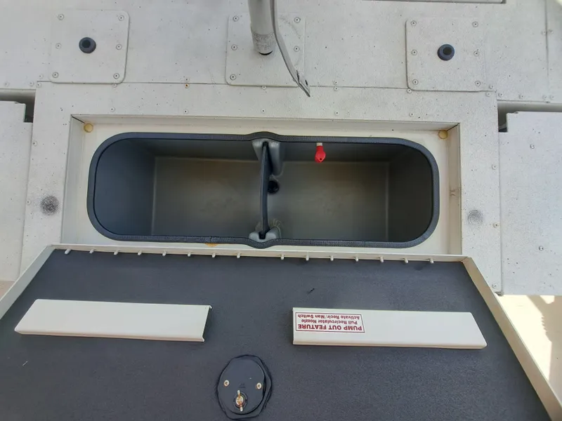 Slide: The Image of An open storage compartment on a 2022 Ranger RB190 boat, featuring a gray interior. - 22