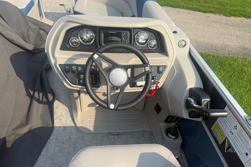 Slide: The Image of Cockpit of 2025 Trifecta 24 RF LE boat with steering wheel and control panel. - 8