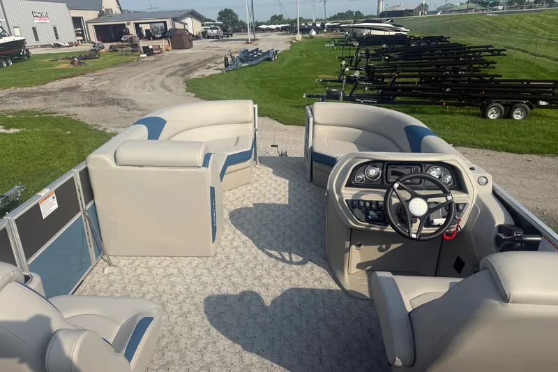 Slide: The Image of 2025 Trifecta 24 RF LE pontoon boat interior with plush seating and modern helm. - 9