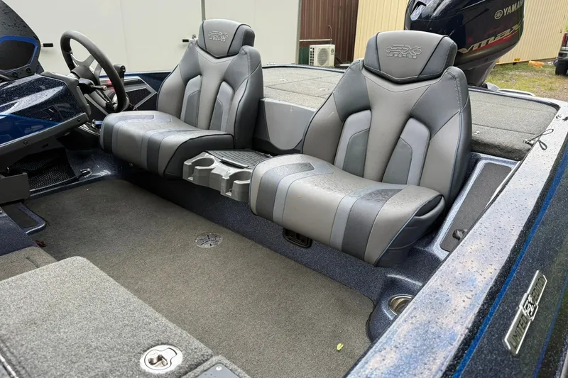 Slide: The Image of 2018 Skeeter FX20 Limited Edition boat interior with dual gray seats and steering wheel. - 13
