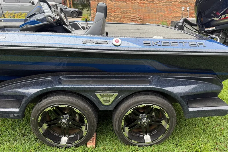 Slide: The Image of 2018 Skeeter FX20 Limited Edition boat with sleek design and dual wheels on grass. - 1