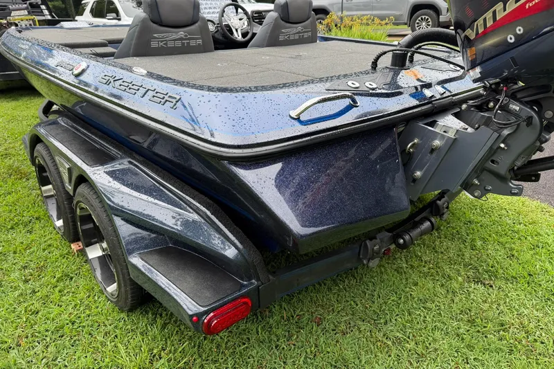 Slide: The Image of 2018 Skeeter FX20 Limited Edition boat on trailer, parked on grass. - 2