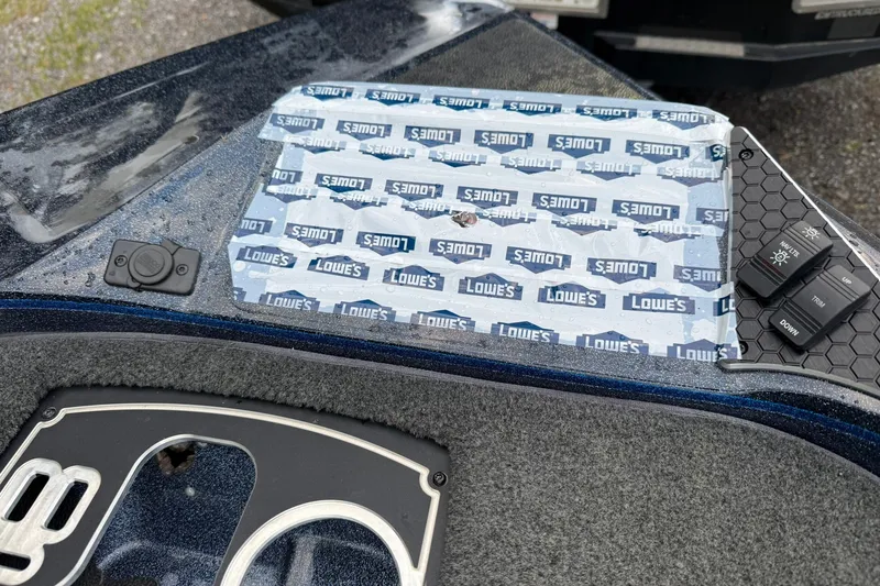 Slide: The Image of 2018 Skeeter FX20 Limited Edition boat dashboard with controls and Lowes-branded protective covering. - 14