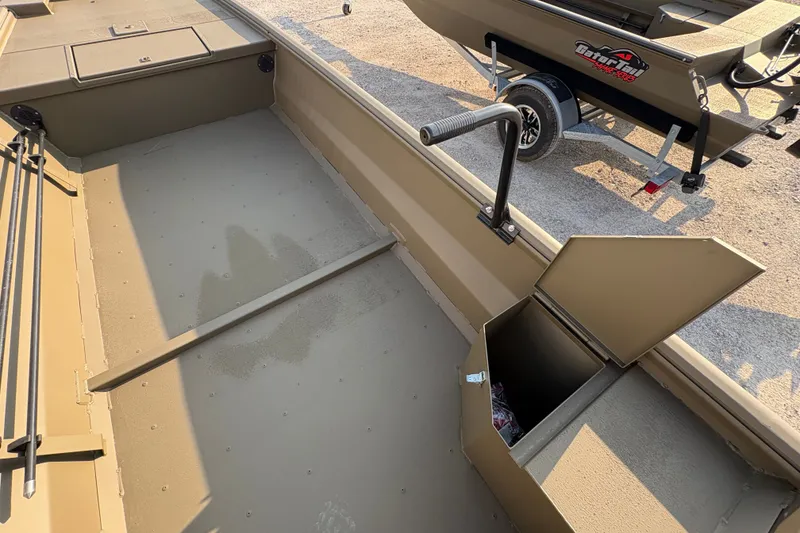 Slide: The Image of 2026 Gator Tail 1748 GATOR boat interior with storage compartment and trailer. - 9