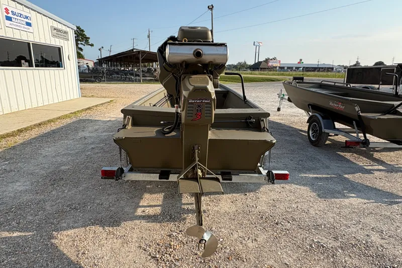 Slide: The Image of 2026 Gator Tail 1748 GATOR boat with motor, parked on gravel near dealership. - 5
