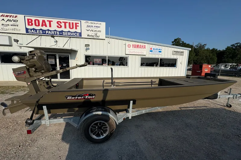 The Image of 2026 Gator Tail 1748 GATOR boat on trailer outside dealership, featuring Yamaha and Suzuki signage. - 1