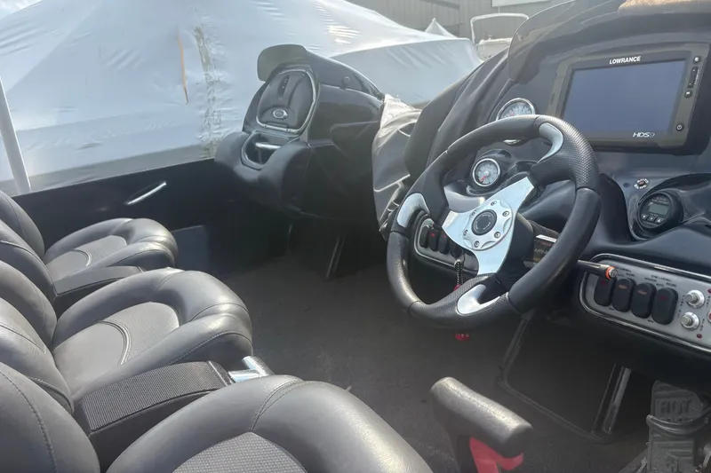 Slide: The Image of Interior of a 2015 Nitro Z-8 DC boat featuring steering wheel and control panel. - 5