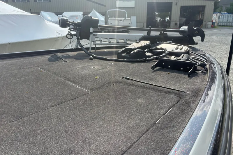 Slide: The Image of 2015 Nitro Z-8 DC boat deck with trolling motor in a marina setting. - 9