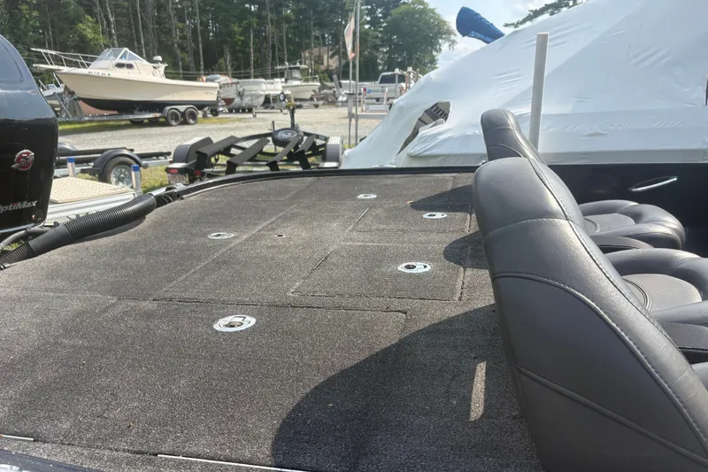 Slide: The Image of 2015 Nitro Z-8 DC boat interior with seating and storage compartments in a marina setting. - 8