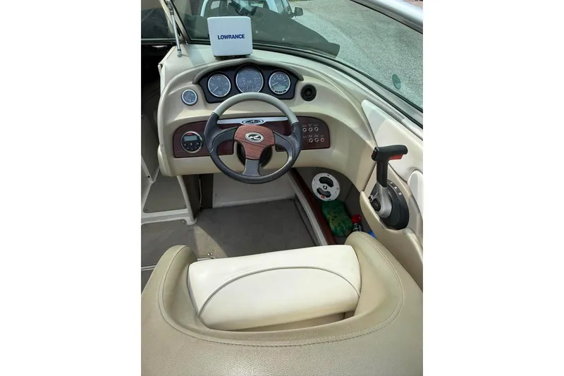 Slide: The Image of 2006 Sea Ray 220 Select boat dashboard with steering wheel and control panel. - 8