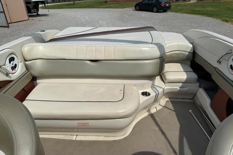 Slide: The Image of 2006 Sea Ray 220 Select boat interior with beige seating and cup holder. - 13