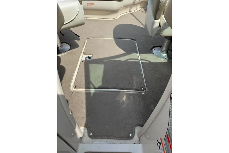 Slide: The Image of Interior view of a 2006 Sea Ray 220 Select boat, featuring carpeted flooring. - 14