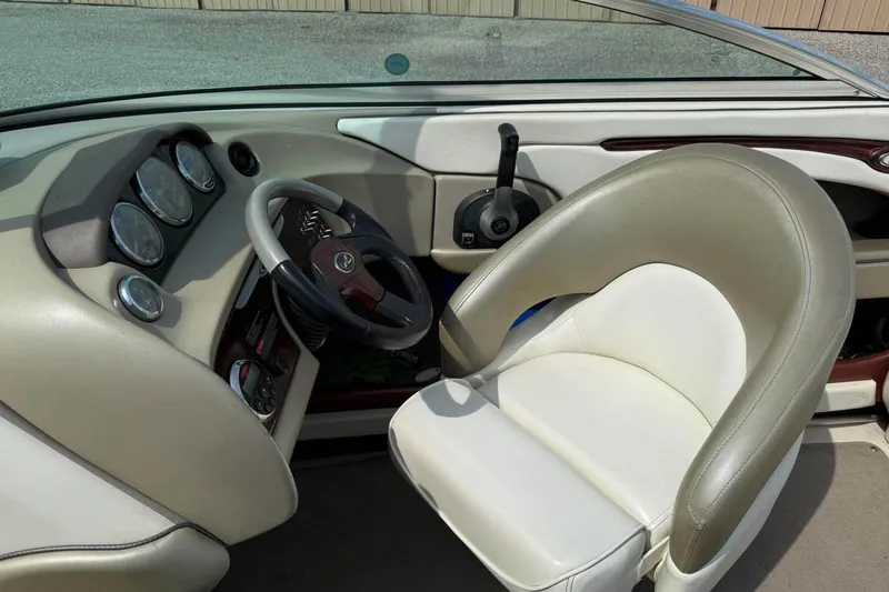 Slide: The Image of Interior of 2006 Sea Ray 220 Select boat, featuring steering wheel and gauges. - 10