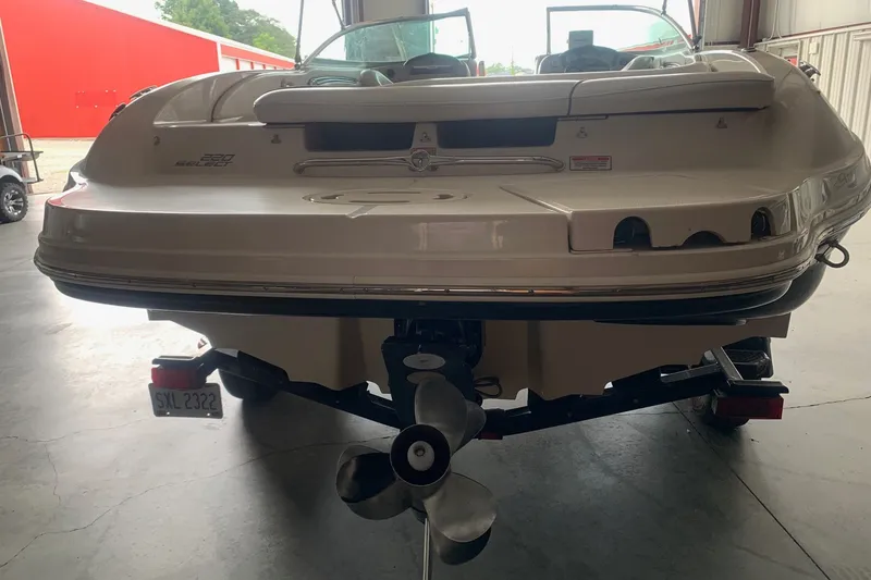 Slide: The Image of Rear view of a 2006 Sea Ray 220 Select boat in a garage setting. - 2