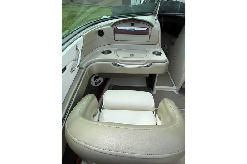 Slide: The Image of Interior of 2006 Sea Ray 220 Select boat with beige seating and dashboard. - 9