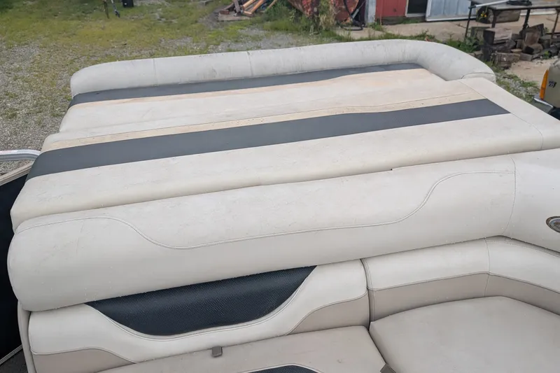 Slide: The Image of 2005 Sylvan 8520 Mirage Cruise RE boat seating, featuring beige and black upholstery. - 6