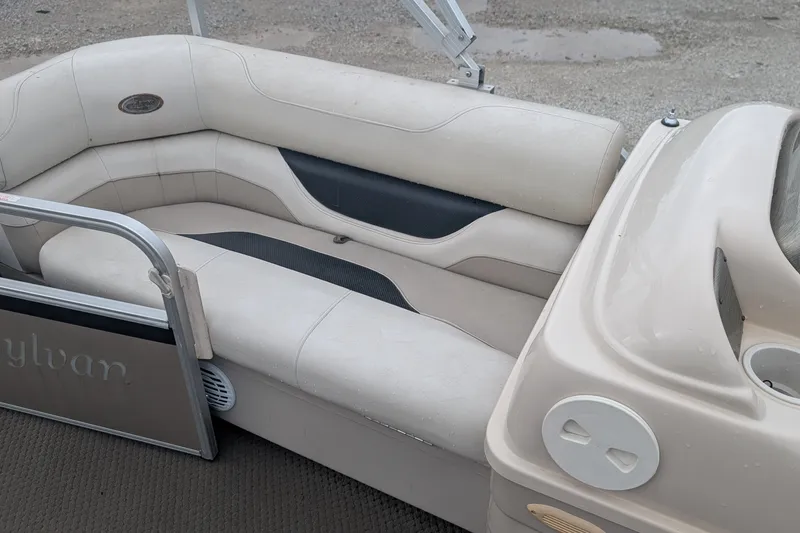 Slide: The Image of 2005 Sylvan 8520 Mirage Cruise RE boat interior with beige seating and sleek design. - 3