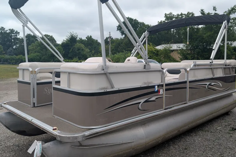 The Image of 2005 Sylvan 8520 Mirage Cruise RE pontoon boat parked on gravel. - 0
