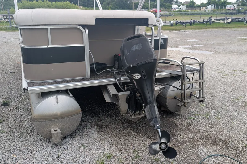 Slide: The Image of 2005 Sylvan 8520 Mirage Cruise RE pontoon boat with outboard motor on gravel. - 9