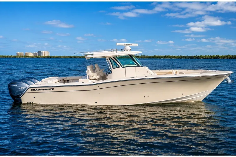 The Image of 2021 Grady-White Canyon 376 boat on calm blue water under a clear sky. - 0