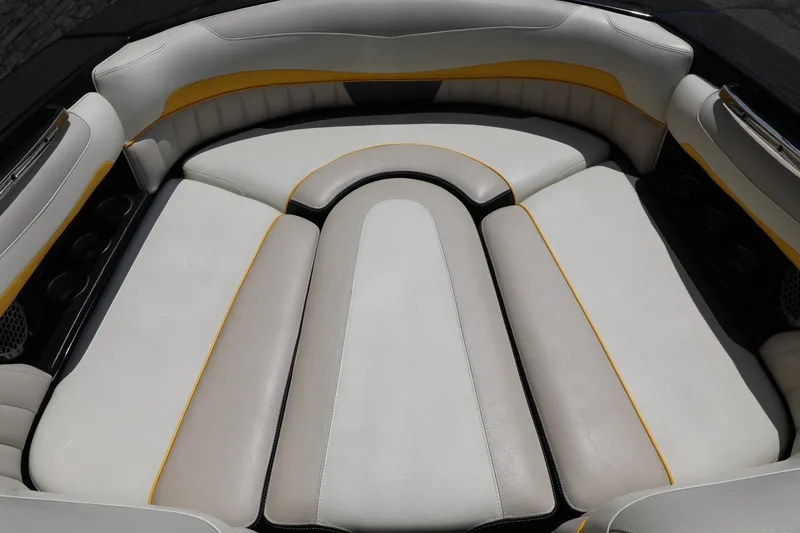 Slide: The Image of 2014 Malibu Wakesetter 22 MXZ interior seating with white and yellow upholstery. - 7