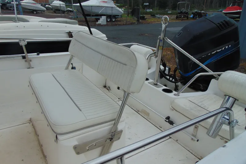 Slide: The Image of 2002 Boston Whaler 160 Dauntless boat interior with seating and motor view. - 5