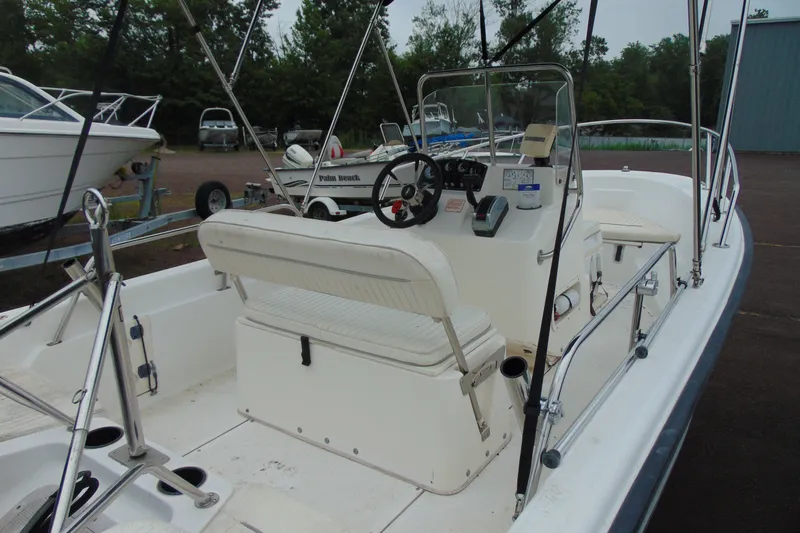 Slide: The Image of 2002 Boston Whaler 160 Dauntless boat interior with steering console and seating. - 8