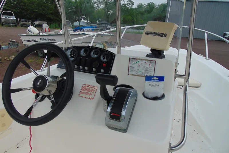 Slide: The Image of 2002 Boston Whaler 160 Dauntless boat console with steering wheel and navigation equipment. - 10