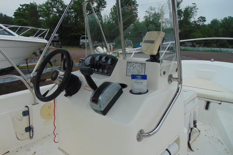 Slide: The Image of 2002 Boston Whaler 160 Dauntless boat console with steering wheel and controls. - 9