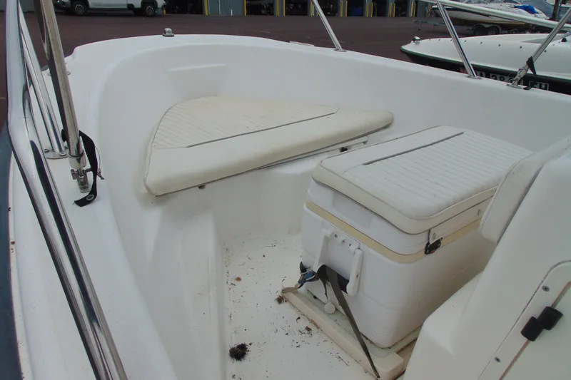 Slide: The Image of 2002 Boston Whaler 160 Dauntless interior with seating and storage compartments. - 6
